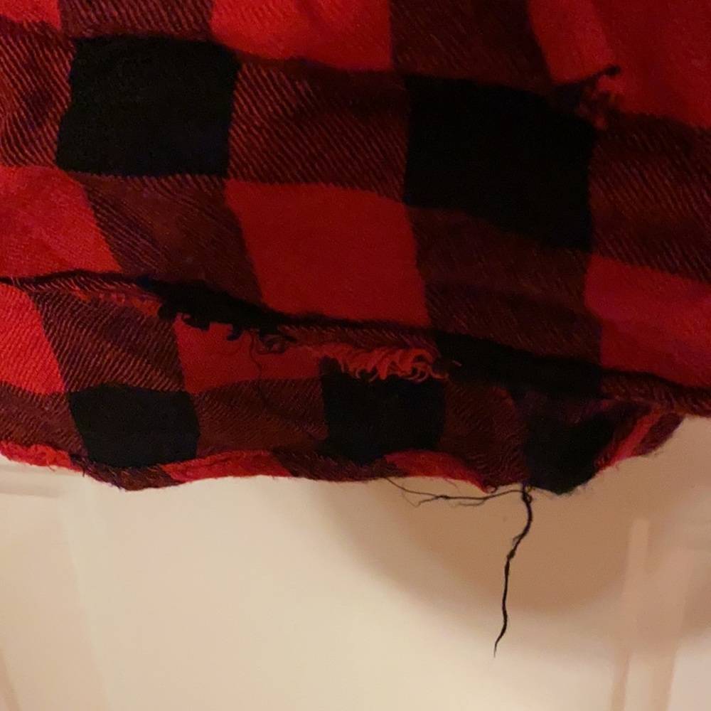 A red and black tank top with cross string over chest - Picture 3 of 7